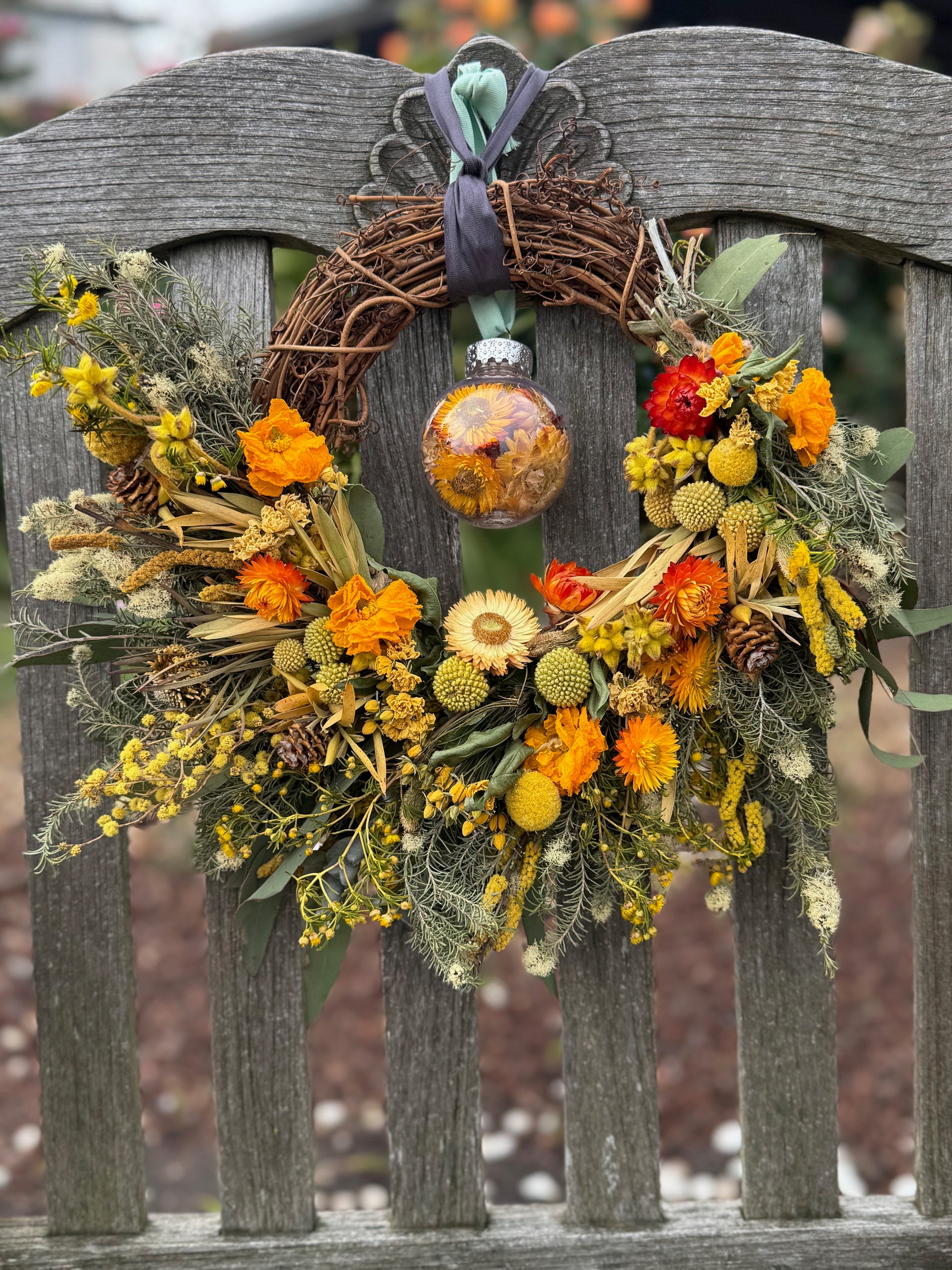 Decorative wreath with yellow flowers and a bauble